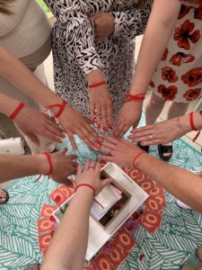 mother blessing hands together, symbolising unity between women during pregnancy and motherhood